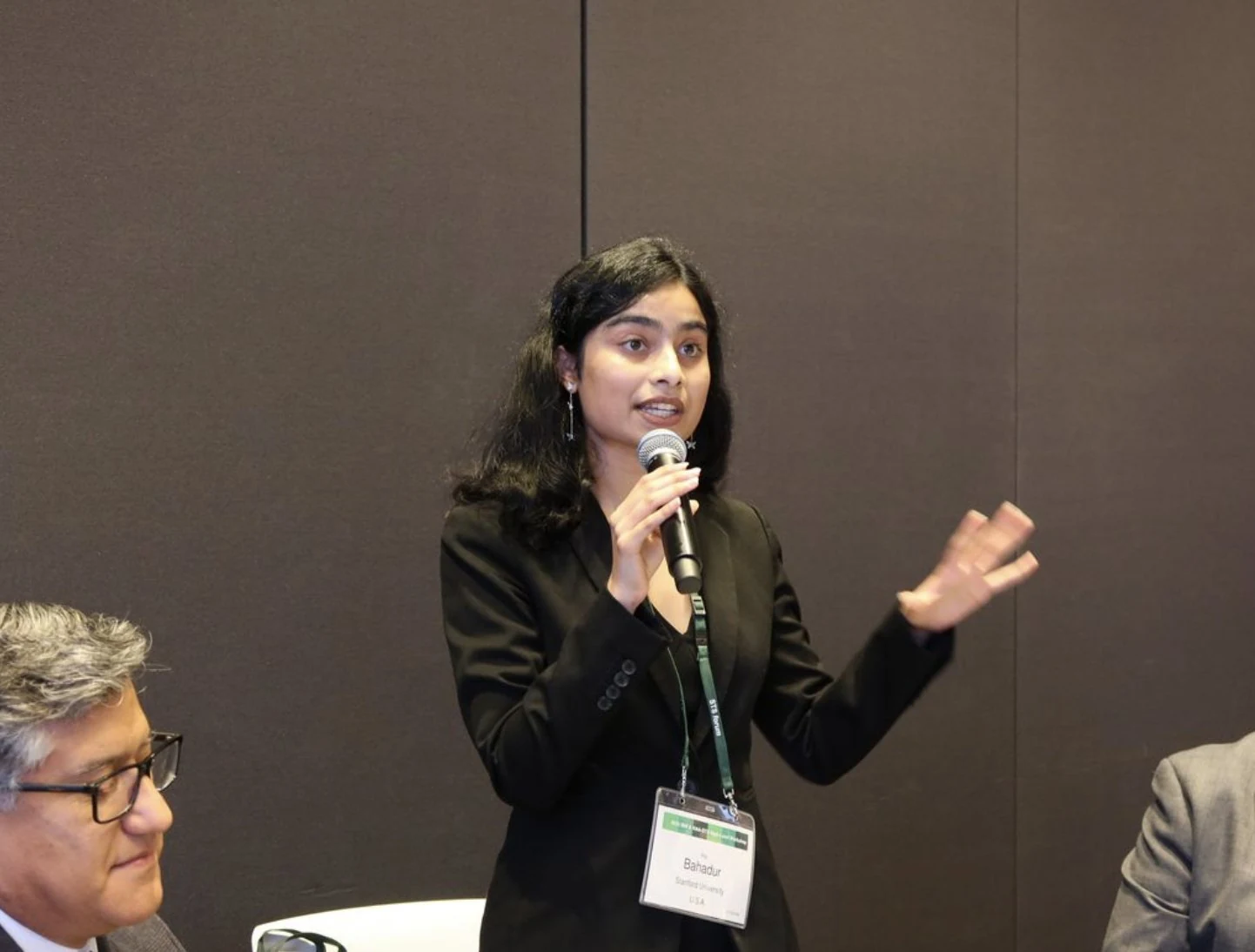 Ria Bahadur speaking into a microphone at the IBM and NAA–STS workshop